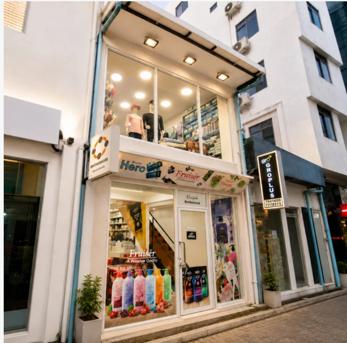 The Brotherhood cosmetics wholesale outlet on Dhanbu Goalhi, Malé, lit up at dusk